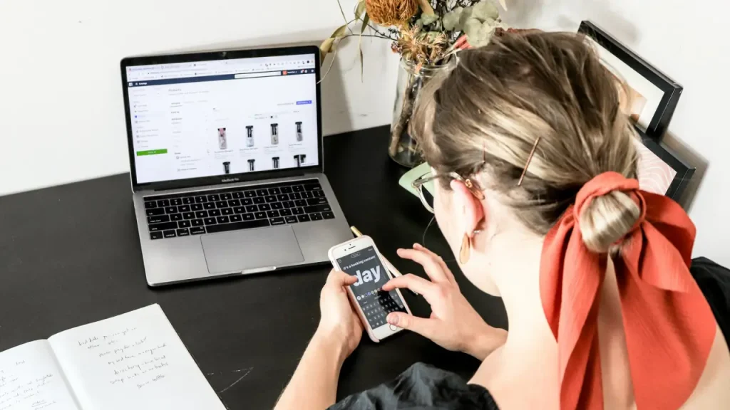 What Makes A Domain Premium? Girl typing on a laptop.