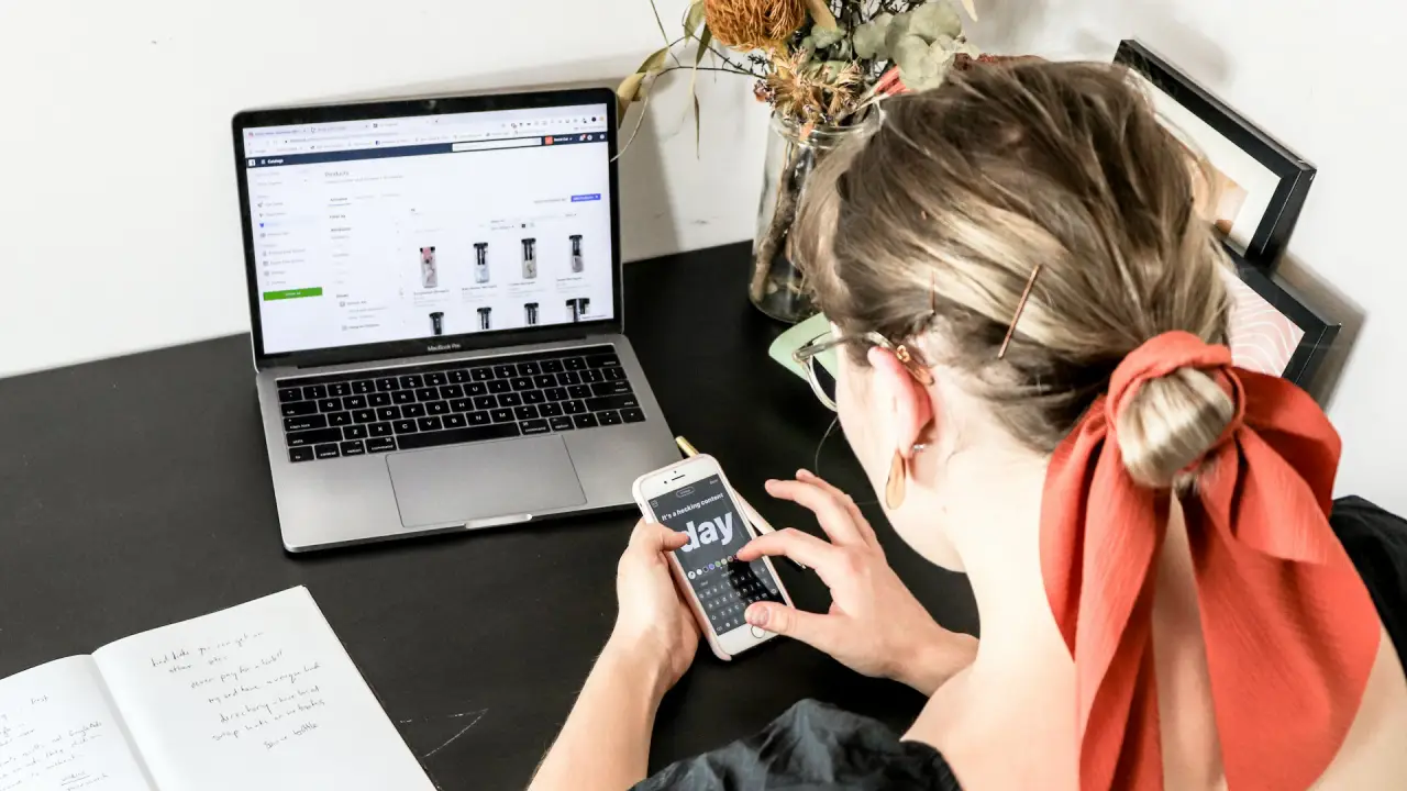 What Makes A Domain Premium? Girl typing on a laptop.